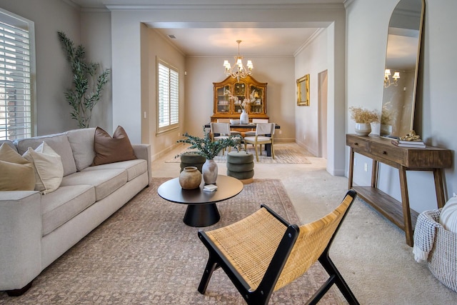 living room featuring crown molding, carpet flooring, arched walkways, and an inviting chandelier