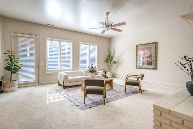 living area with carpet floors, visible vents, and baseboards