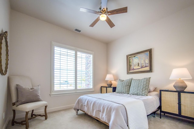 carpeted bedroom with a ceiling fan, visible vents, and baseboards