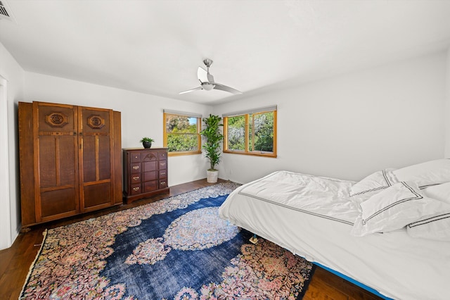bedroom with visible vents, a ceiling fan, and wood finished floors