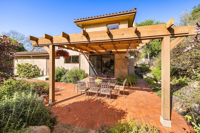 exterior space with a pergola and outdoor dining space