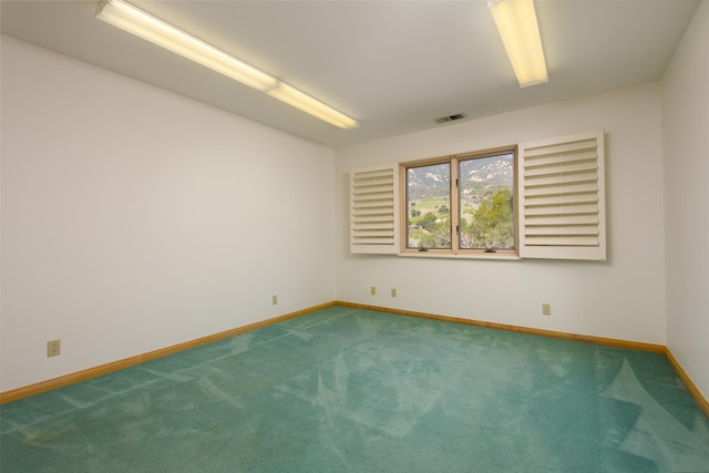 unfurnished room featuring baseboards, visible vents, and carpet flooring