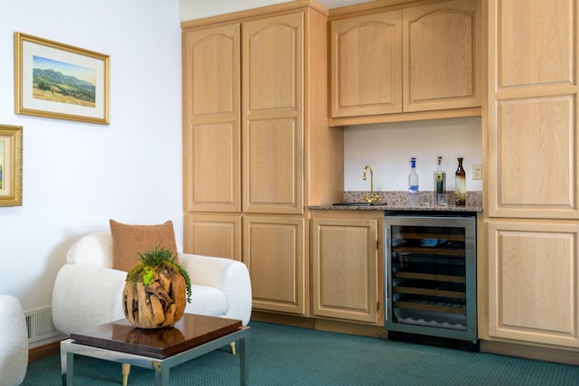 bar featuring beverage cooler, dark colored carpet, indoor wet bar, and a sink