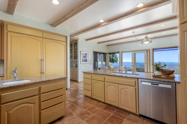 kitchen featuring a sink, light brown cabinets, stainless steel dishwasher, and beamed ceiling