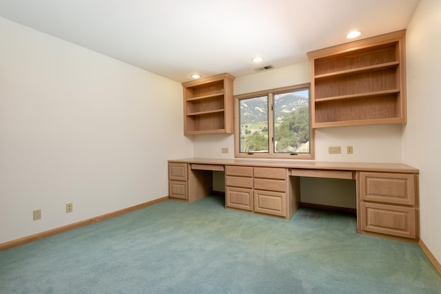 unfurnished office featuring recessed lighting, light colored carpet, visible vents, baseboards, and built in desk