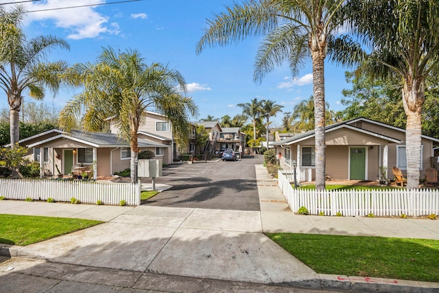 view of road with a residential view and concrete driveway