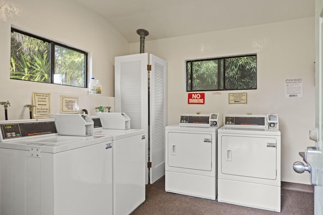 common laundry area featuring separate washer and dryer and dark colored carpet