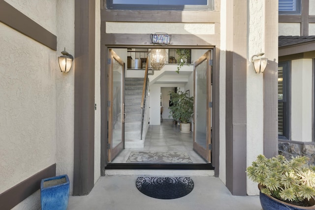 view of exterior entry with stucco siding