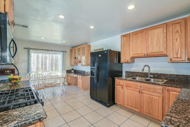 kitchen with black appliances, recessed lighting, a sink, and light tile patterned flooring