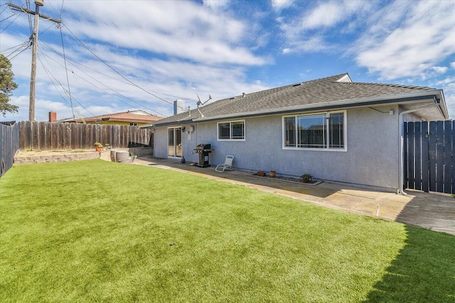 rear view of property with a patio area, a fenced backyard, a lawn, and stucco siding