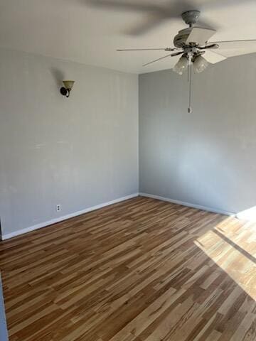 unfurnished room featuring wood finished floors, a ceiling fan, and baseboards