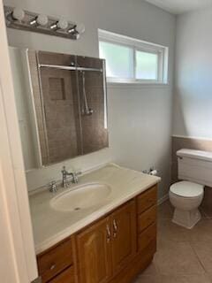 bathroom with toilet, tile patterned floors, vanity, and a shower with shower door