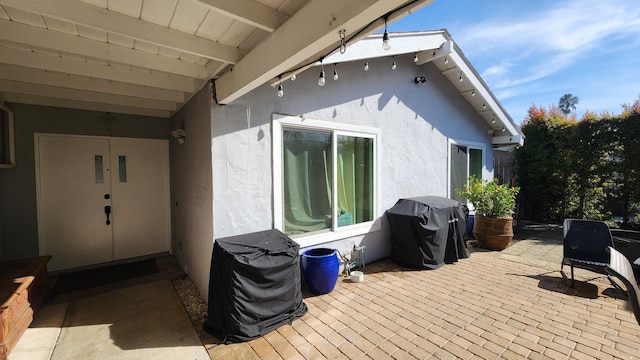 wooden deck with a patio area and area for grilling