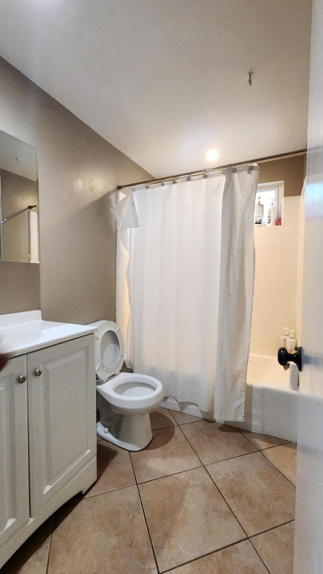 bathroom featuring shower / tub combo, tile patterned flooring, vanity, and toilet