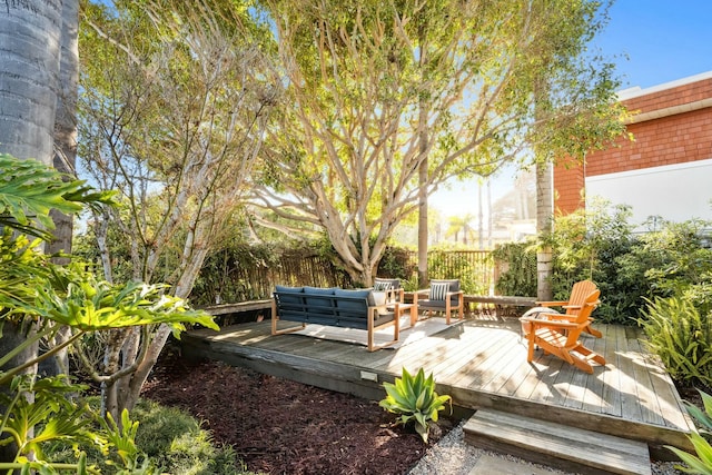 view of patio / terrace with an outdoor hangout area, a deck, and fence