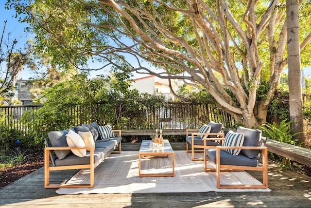 view of patio / terrace with an outdoor living space, a deck, and fence