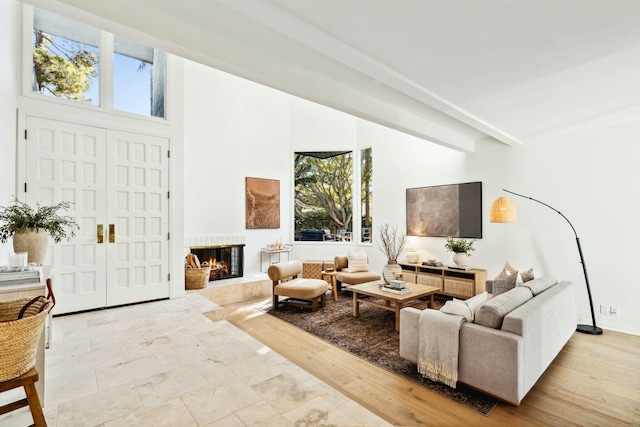 living room with a multi sided fireplace and beam ceiling