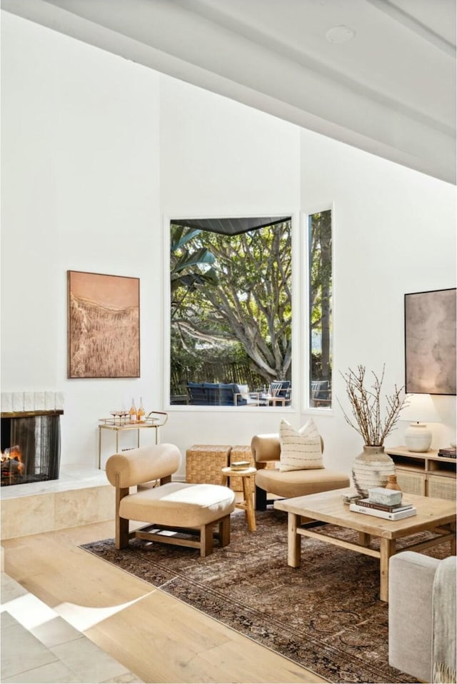 sitting room featuring a tile fireplace