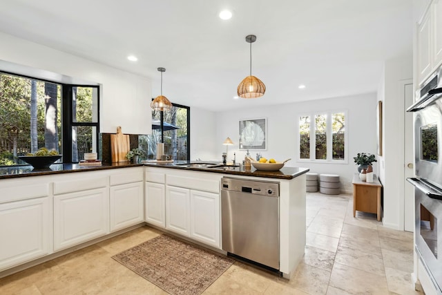 kitchen featuring pendant lighting, a sink, recessed lighting, stainless steel appliances, and white cabinets