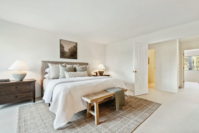 bedroom featuring light carpet