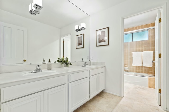 full bath with tile patterned floors, a sink,  shower combination, double vanity, and baseboards