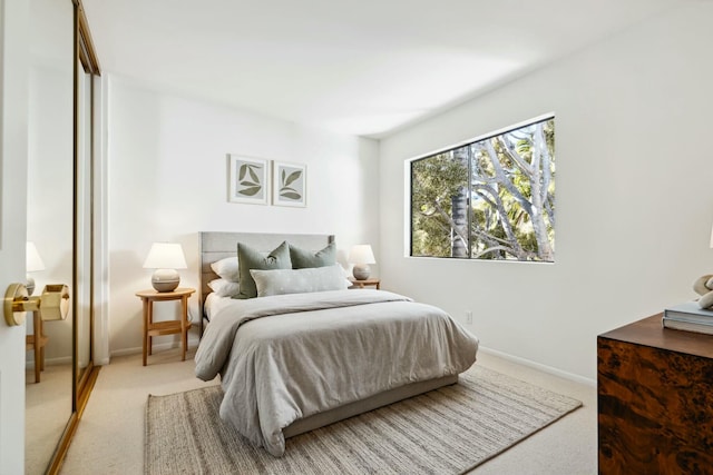 bedroom featuring baseboards and carpet