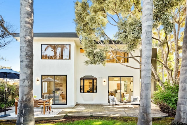 back of house featuring stucco siding and a patio