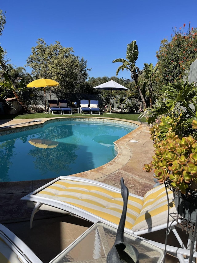 view of pool featuring a patio area, fence, and a fenced in pool