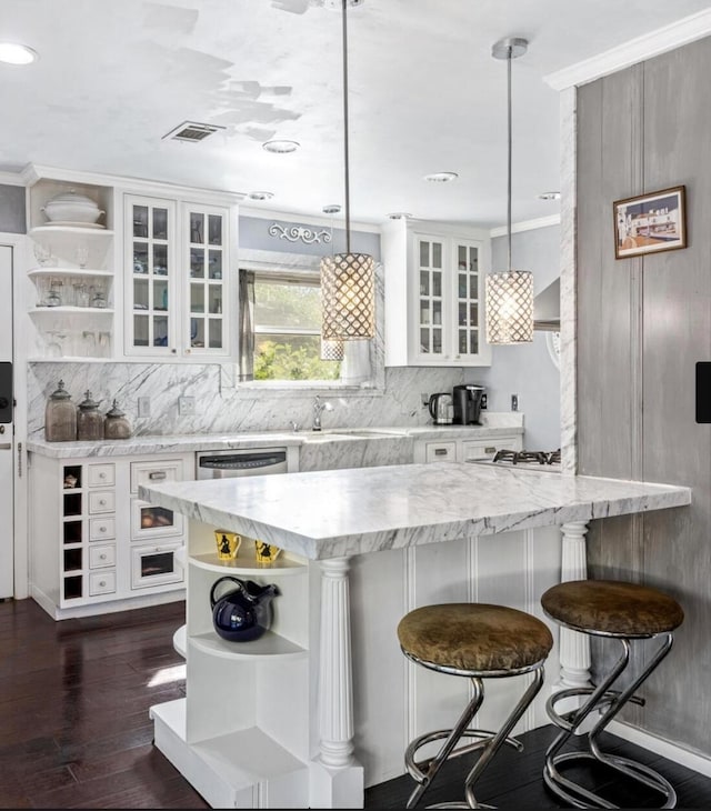 kitchen with open shelves, dark wood finished floors, backsplash, and white cabinetry