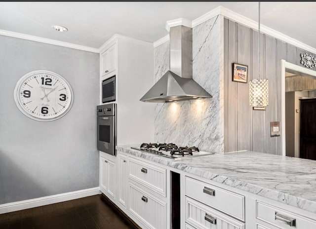 kitchen featuring wall chimney range hood, appliances with stainless steel finishes, backsplash, and ornamental molding