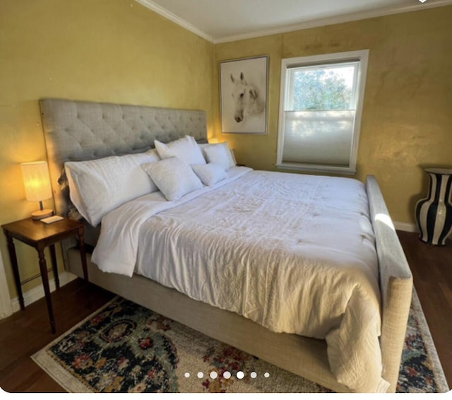 bedroom featuring ornamental molding, baseboards, and wood finished floors