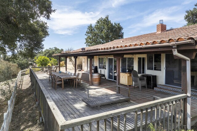 wooden deck featuring outdoor dining space