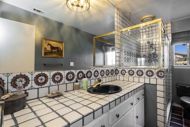 full bath featuring a wealth of natural light, visible vents, vanity, and toilet