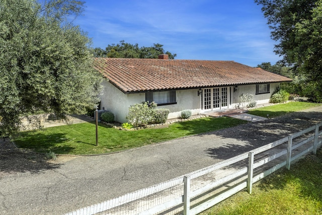 3776 Live Oak Rd, Santa Ynez, CA 93460 - view of front of home with fence, a chimney, stucco siding, french doors, and a front lawn