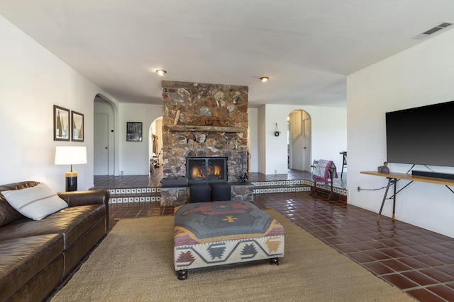 3776 Live Oak Rd, Santa Ynez, CA 93460 - living area with arched walkways, visible vents, and a stone fireplace