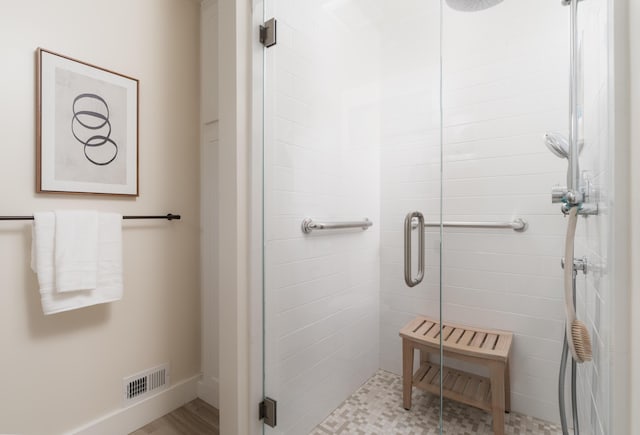 bathroom featuring visible vents and a shower stall