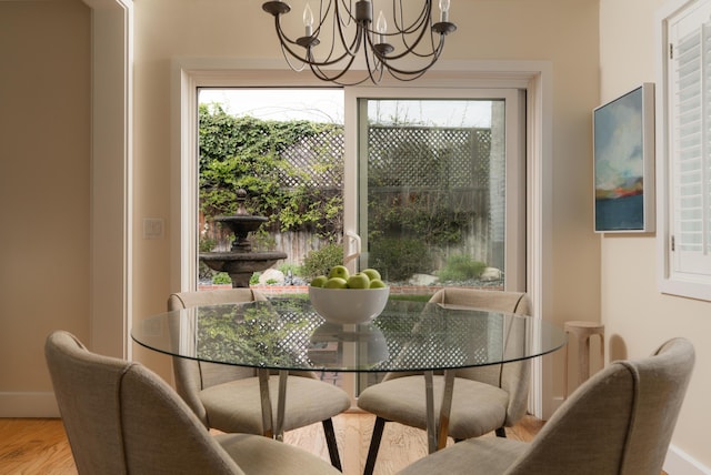 dining space with a notable chandelier and wood finished floors