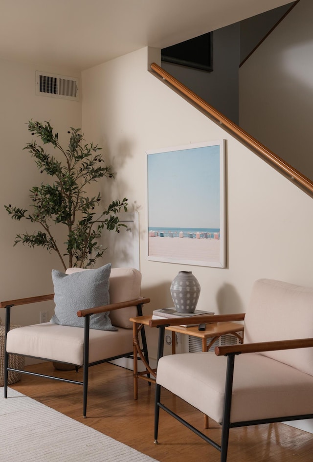 sitting room with visible vents and wood finished floors