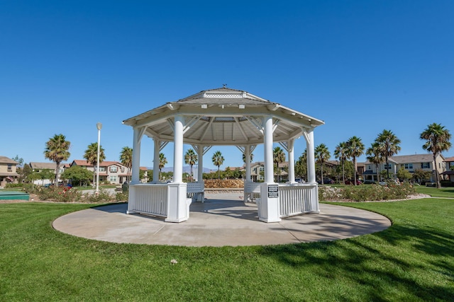 view of community featuring a patio area, a yard, and a gazebo