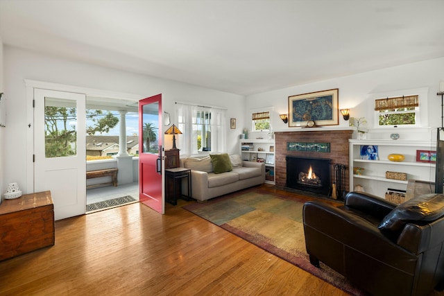 living room with a fireplace and wood finished floors