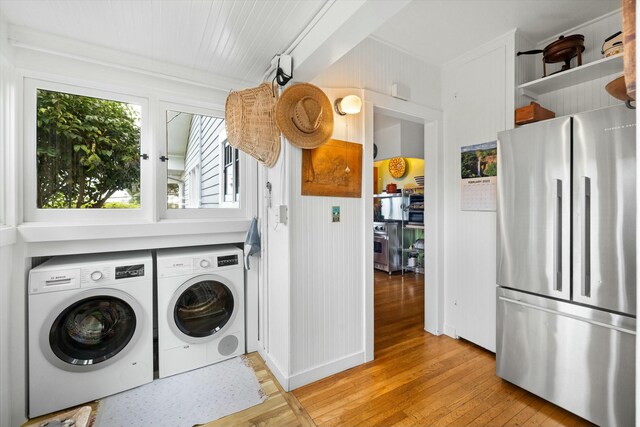 washroom featuring laundry area, light wood-type flooring, and washer and dryer