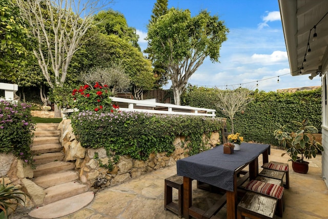 view of patio / terrace with outdoor dining area and fence