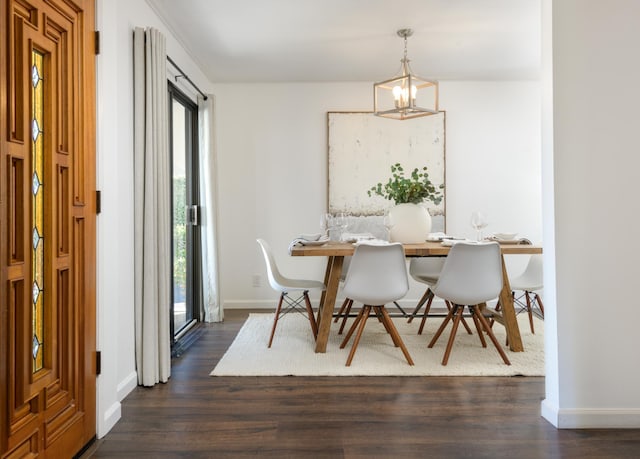 dining room featuring baseboards, dark wood finished floors, and a notable chandelier