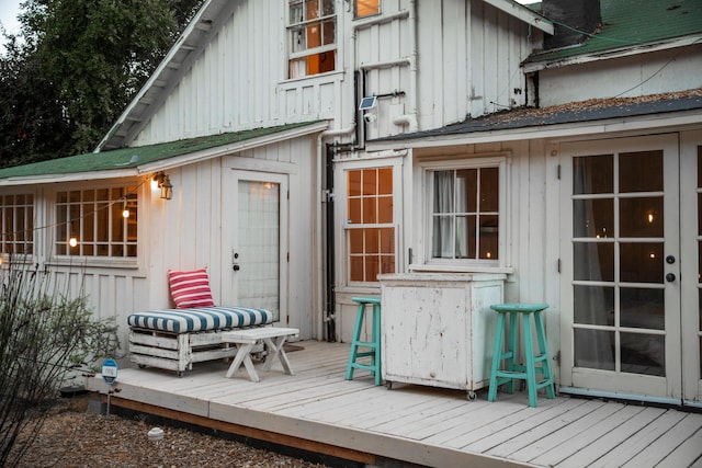 back of property featuring board and batten siding and a wooden deck