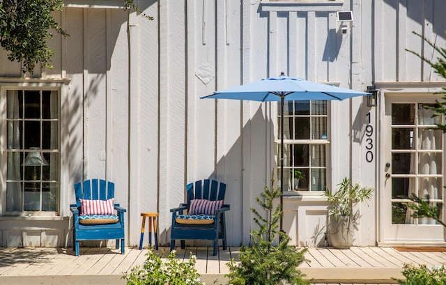 entrance to property featuring a deck and board and batten siding