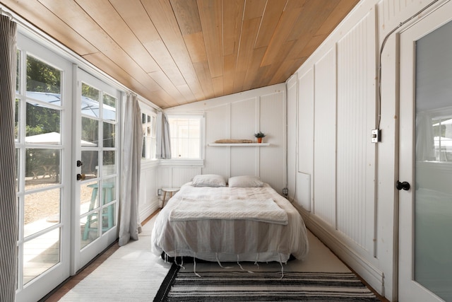 bedroom featuring vaulted ceiling, french doors, wooden ceiling, and access to exterior