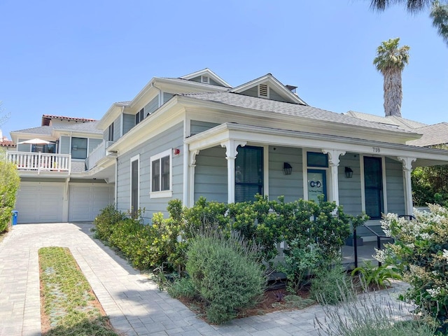 view of front of property featuring covered porch, driveway, and an attached garage