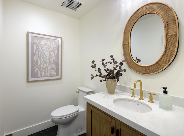 half bathroom with visible vents, toilet, and vanity