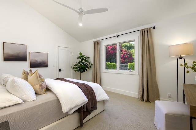 bedroom with ceiling fan, baseboards, vaulted ceiling, and light carpet