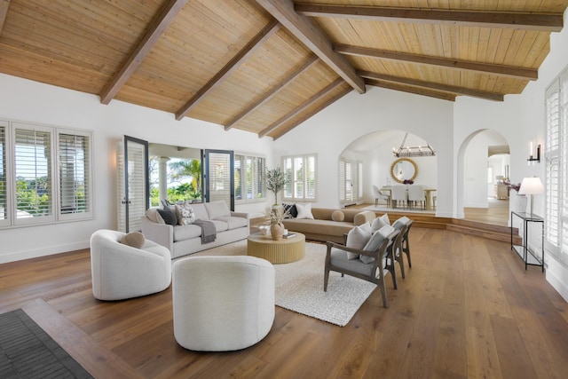 living room featuring baseboards, wooden ceiling, arched walkways, and wood-type flooring